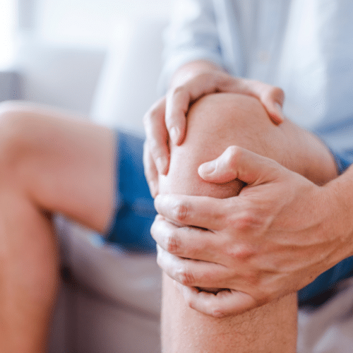 Man holding knee suffering from Knee Osteoarthritis